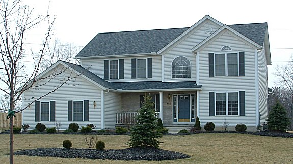 Vaulted family room opens to 2nd floor hall. Formal living and dining rooms. Cathedral master bedroom. 1st floor laundry. Covered porch with post and wood railing. Brick or stone porch wall.  2-car garage.